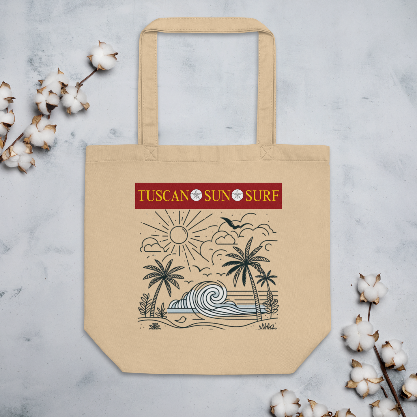 Tan eco tote bag with black line drawing of a beach wave, palm trees, sun, clouds and birds in the sky. The Tuscan Sun Surf logo is at the top