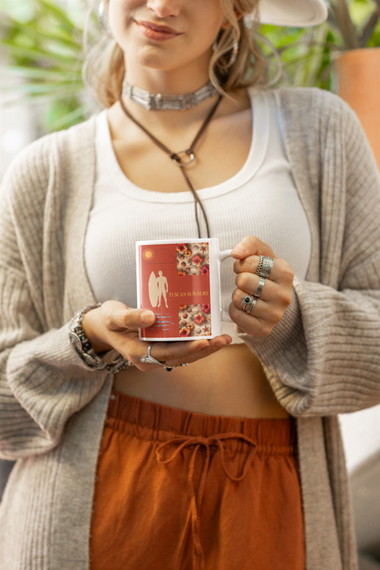 Boho girl holding a white 11 oz mug with burnt orange design with outline of tan surfer with surf board. Mug has a Tuscan Sun Surf label and hibiscus flowers