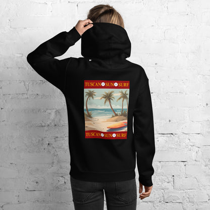 Back of a woman wearing a black unisex hoodie with a graphic design of a beach with palm trees and an orange and yellow surf board. The Tuscan Sun Surf logo borders above and below the design