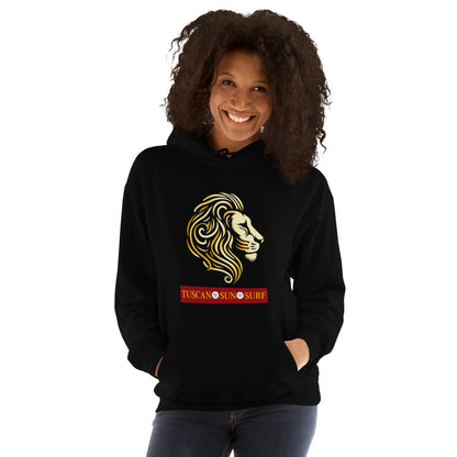 Woman wearing a unisex black hoodie with a lion head in shades of yellow. Below the lion face is the Tuscan Sun Surf logo.